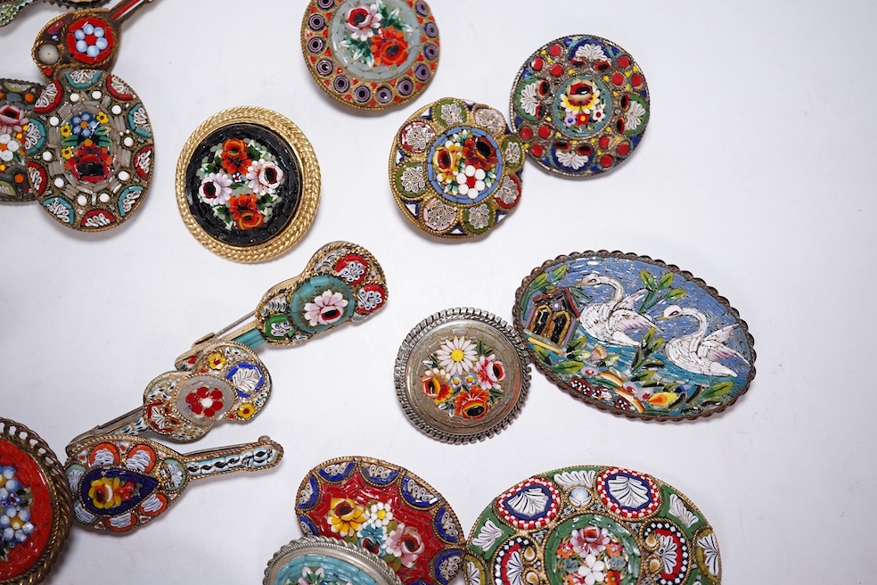 Thirty-one costume micro-mosaic brooches, to include seventeen guitar and banjo shaped brooches, five large oval/ circular brooches including scenic swan brooch, eight, smaller brooches and a pendant. Condition - fair/go